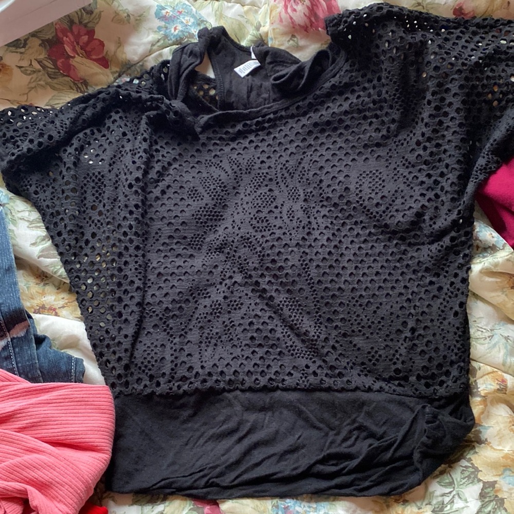 A black short sleeve shirt; has an attachment underneath